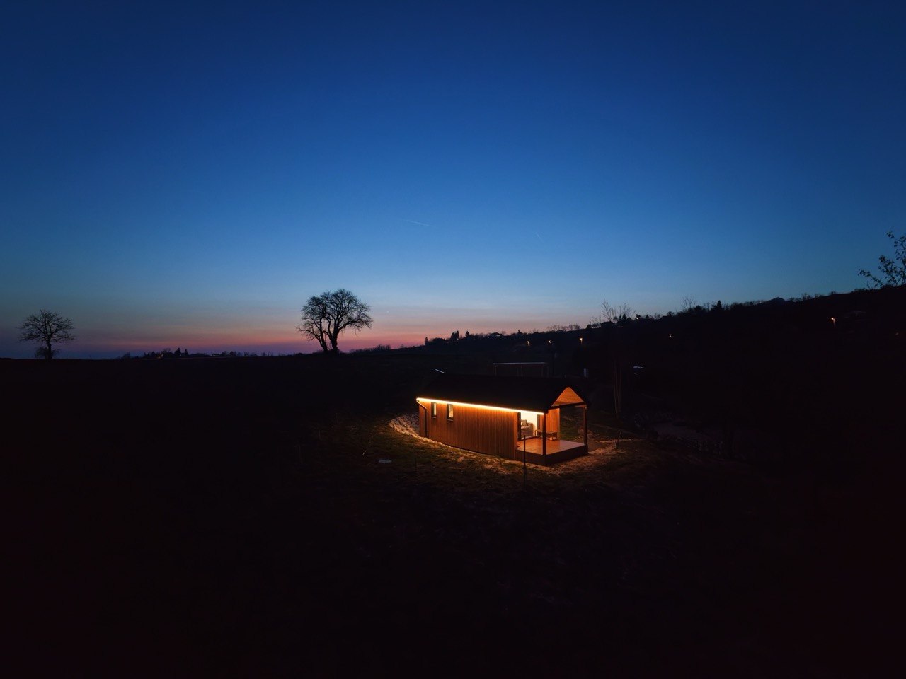 Dushka cabin glowing at night